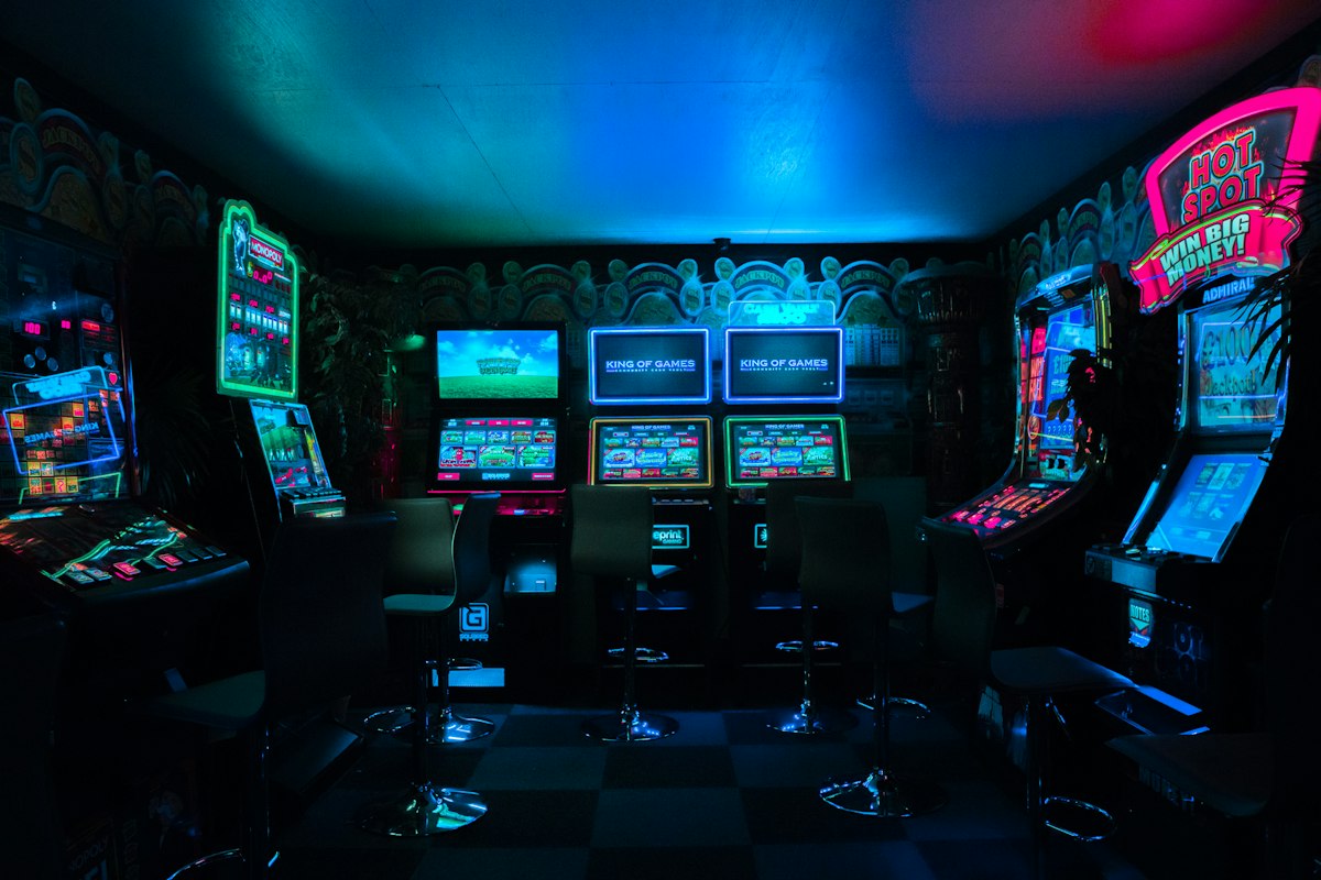Gamer playing competitive game in ambient dark room